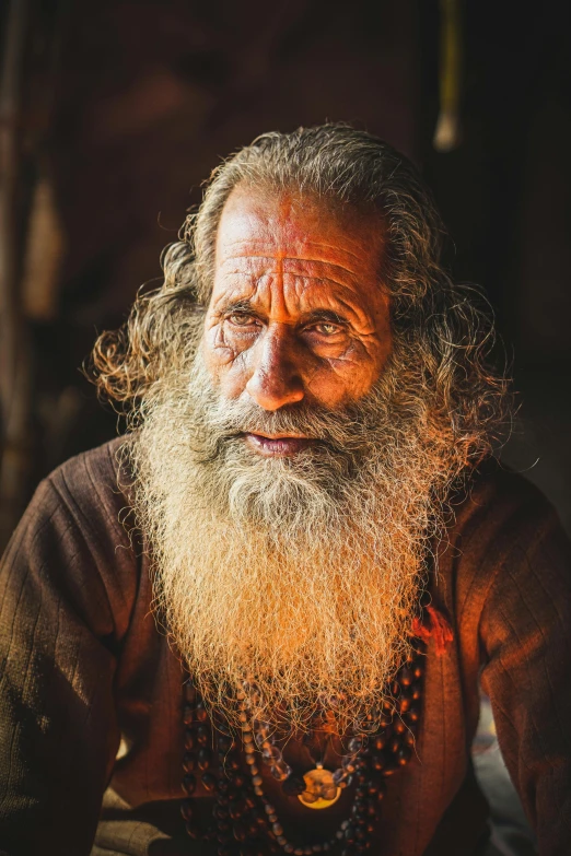 an old man with a long beard and beads