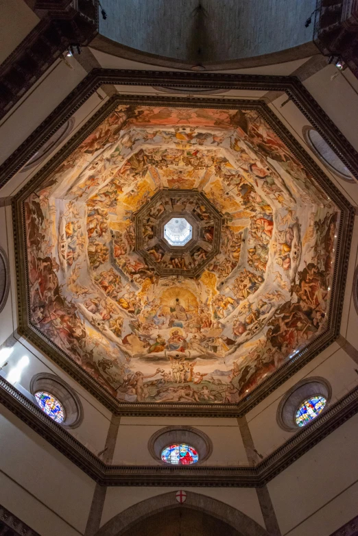 a ceiling with paintings on it in a church