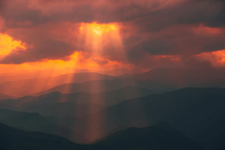 a large mountain range with many dark clouds