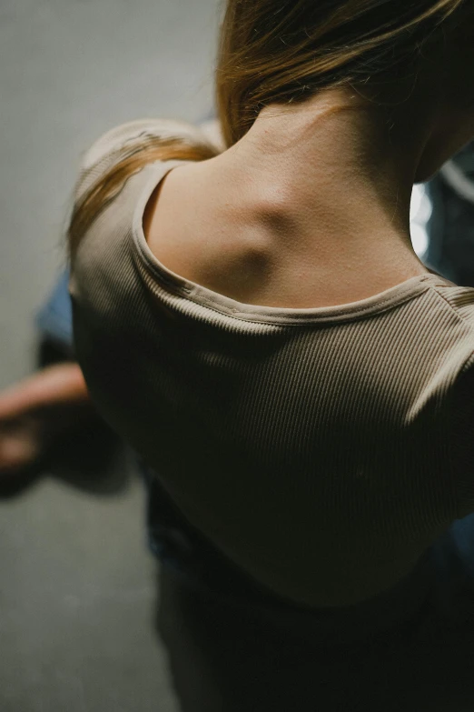 a woman wearing a turtle neck sweater pulling up her hair