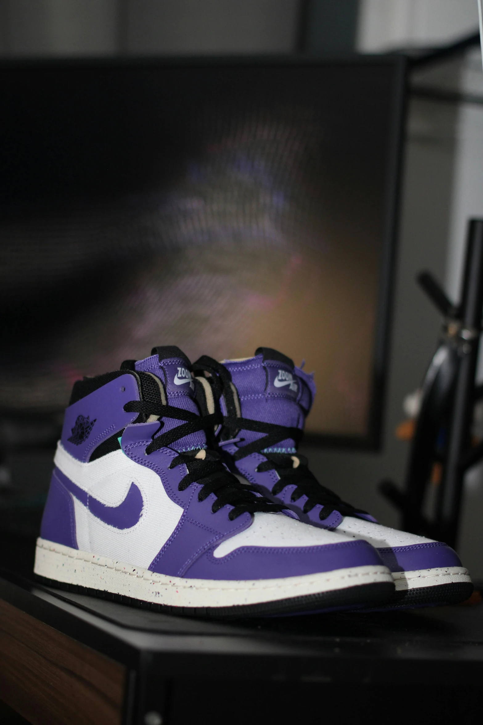 two purple sneakers on top of a table