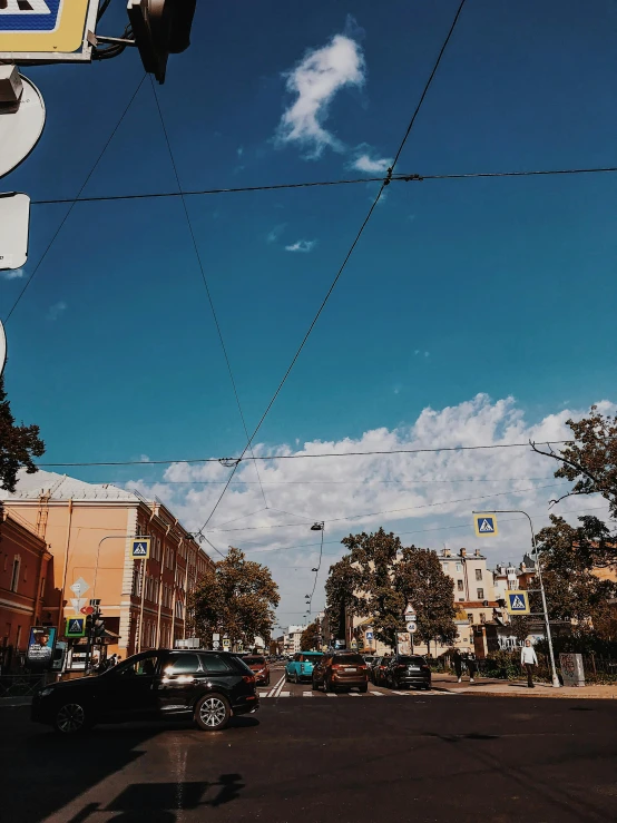 a street sign with wires crossing over it