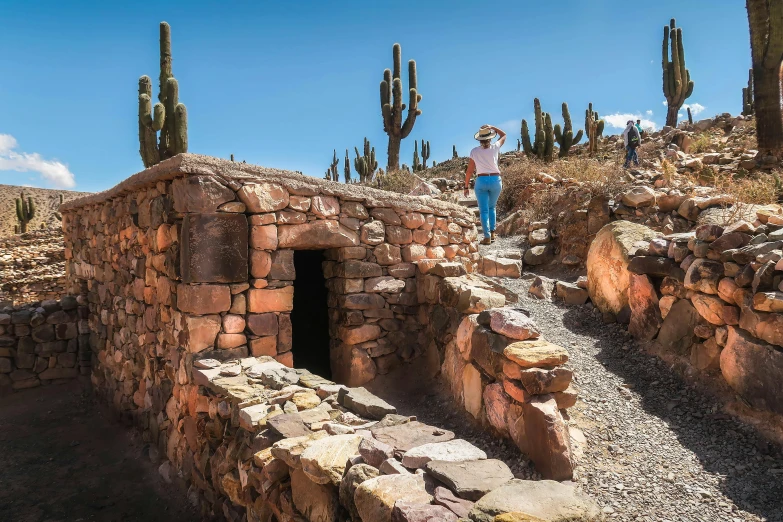 a man standing next to a well made out of bricks