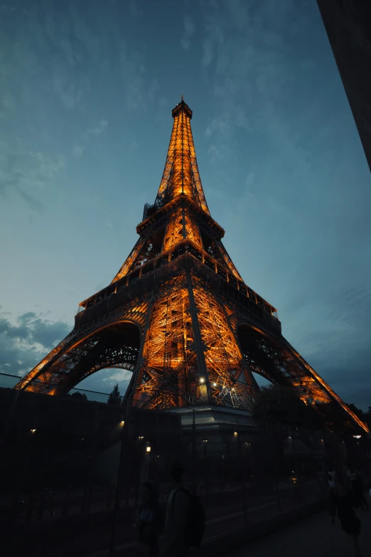 the eiffel tower in paris is lit up at night