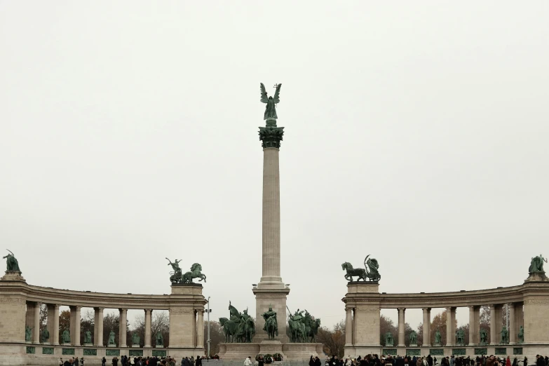 an enormous monument surrounded by statues is pictured