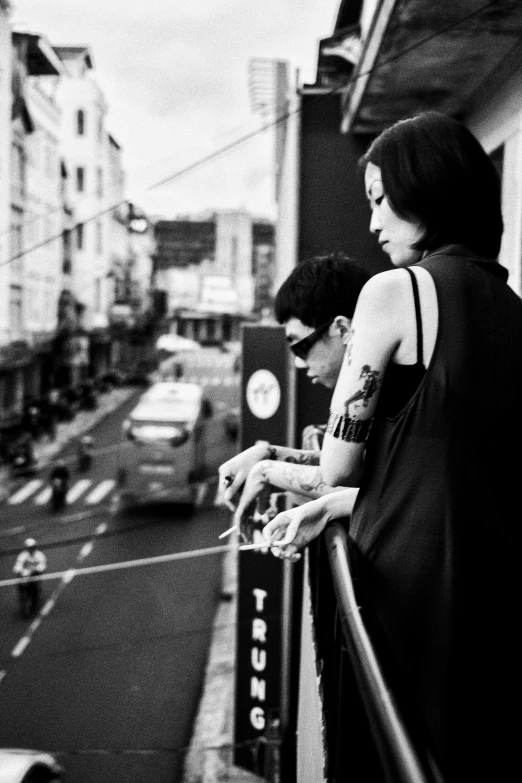 a couple of people standing on top of a city street