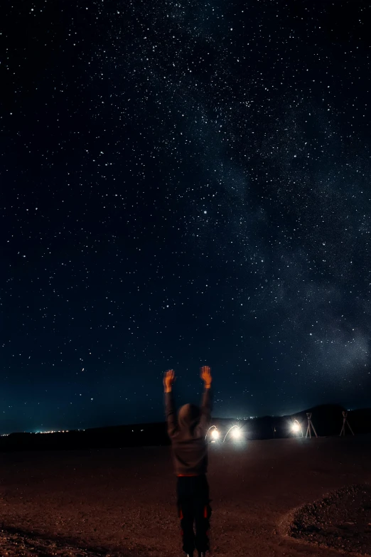 a man is standing alone with his arms in the air