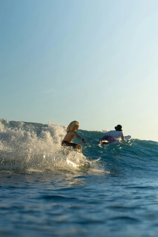 surfer on surfboard, riding waves in open area