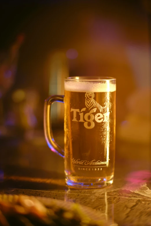 a glass of beer sitting on top of a counter