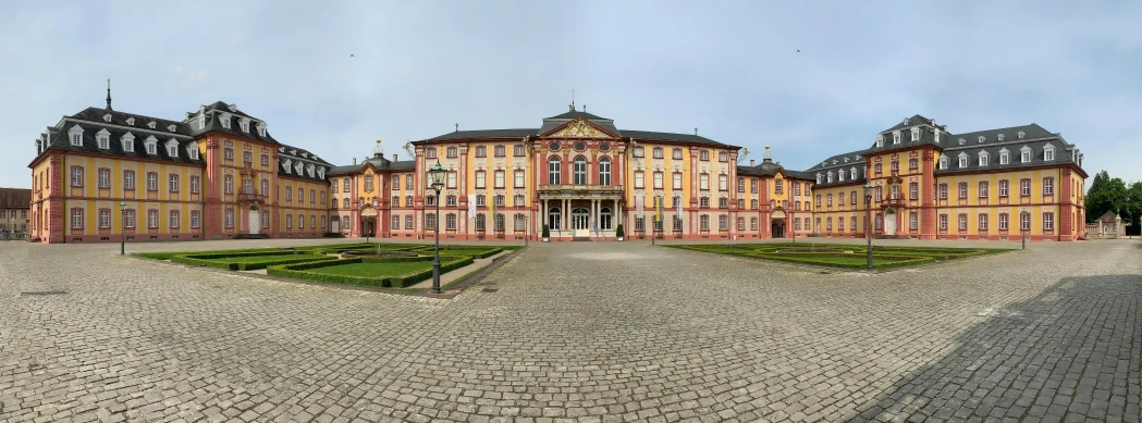 a large building with several stories next to grass