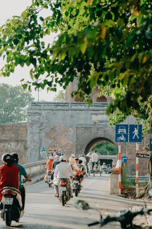 several people on bikes riding through a tunnel