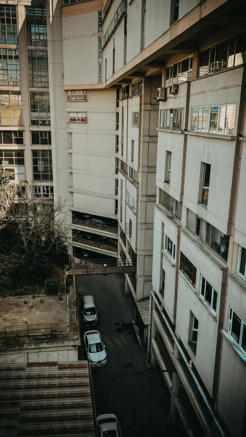 a view of some buildings with cars driving down them