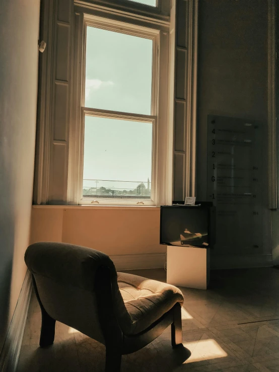 a chair in the corner of a room with windows