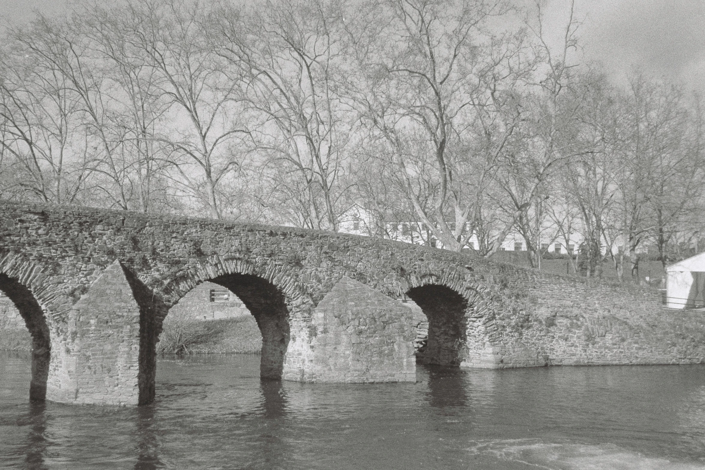 a bridge is partially submerged in water with no traffic