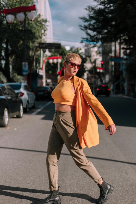 a person crossing the street in an orange shirt