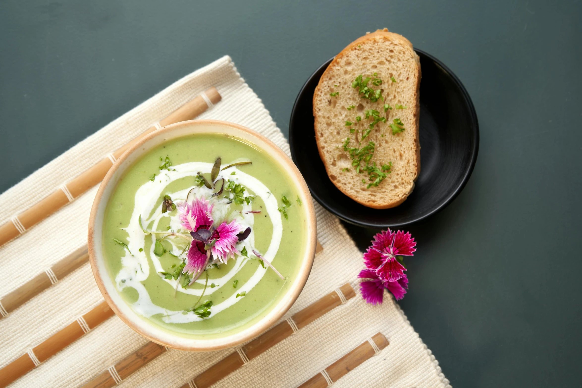 a bowl with soup and a plate on a place mat