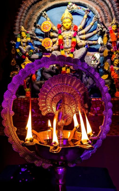 a purple plate on top of a counter with candles burning