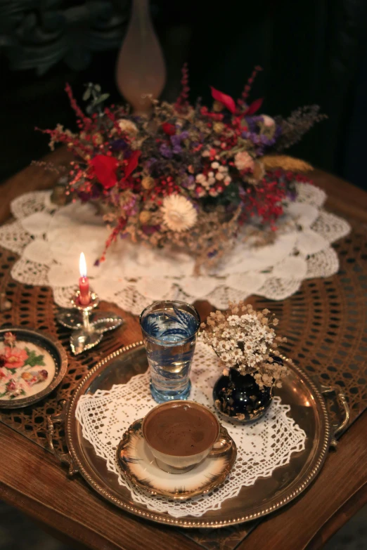 the table is set for four, with three plates and two candles