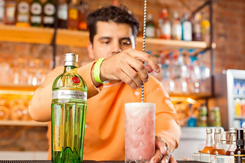 a man is making a beverage at the bar