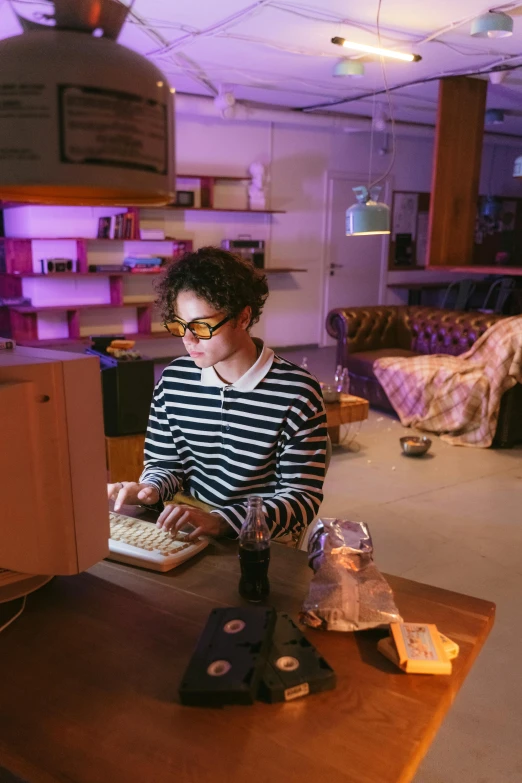 a woman typing on a keyboard at the end of a table