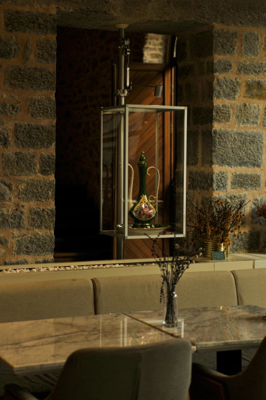 a dining room table and a bench with a vase filled with flowers