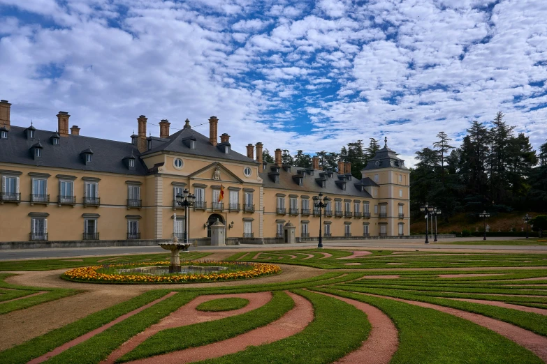 an old building with a nice garden in the front