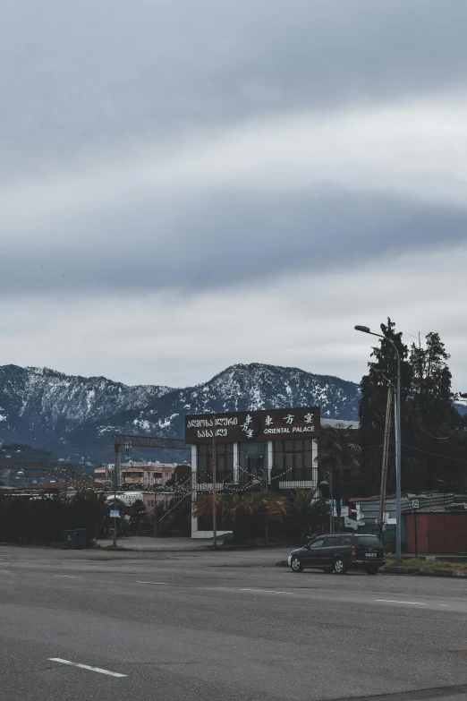 cars are parked in an empty lot near mountains