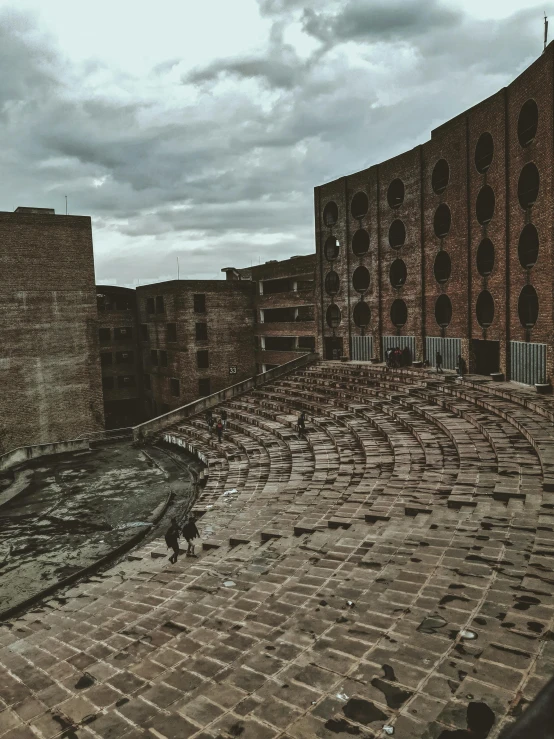 an empty walkway near a large brick building