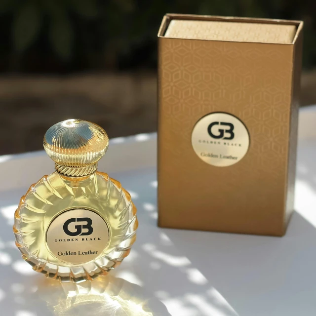 a bottle of goldfinger perfume sitting on top of a white table