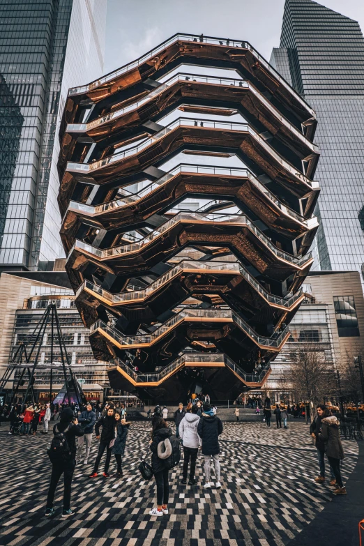 some people standing around in front of a tall building