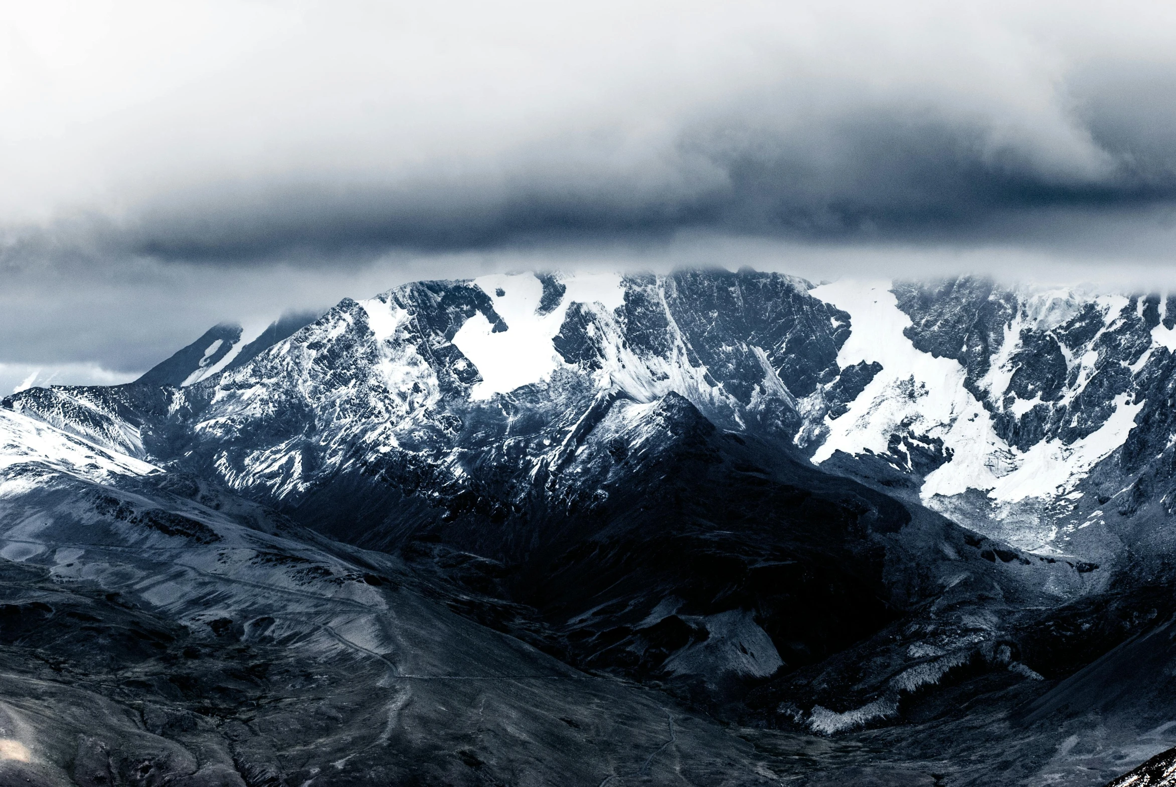 snow capped mountains under an overcast sky