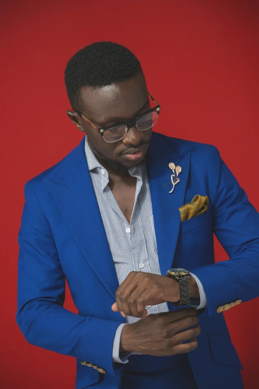 a man looking at his cell phone wearing a blue suit