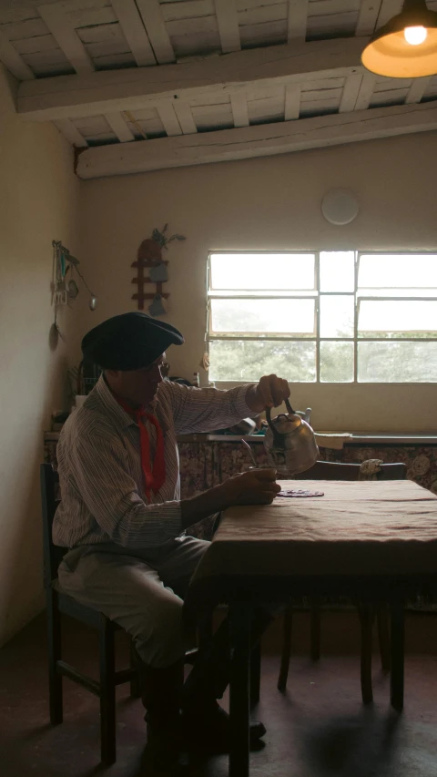 the lady is painting at the table alone