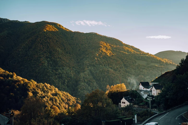 a scenic view of a road in a mountainous valley