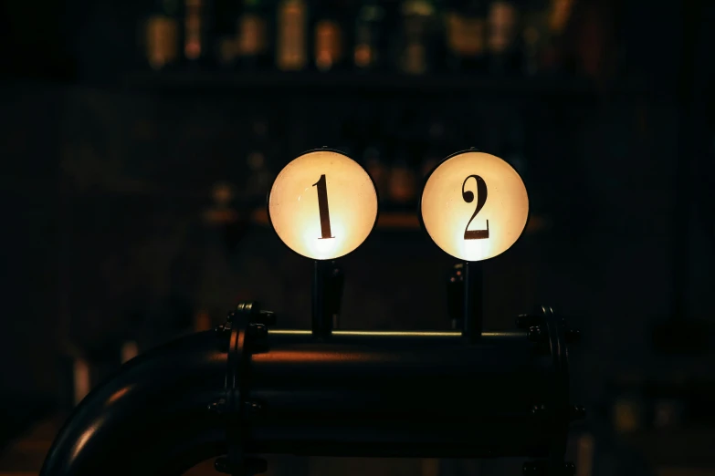 two glowing candles in the shape of numbers