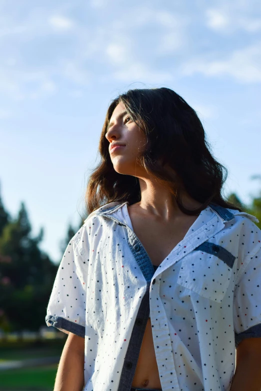 a woman looks over her shoulder in the sky