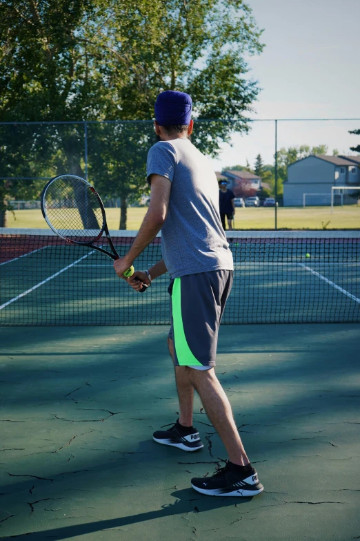 a tennis player waits to hit the ball