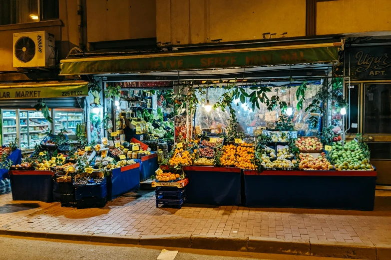 a fruit stand with many different fruits and vegetables