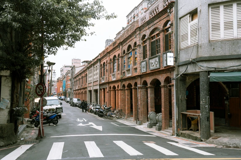 the cars are parked along the brick street