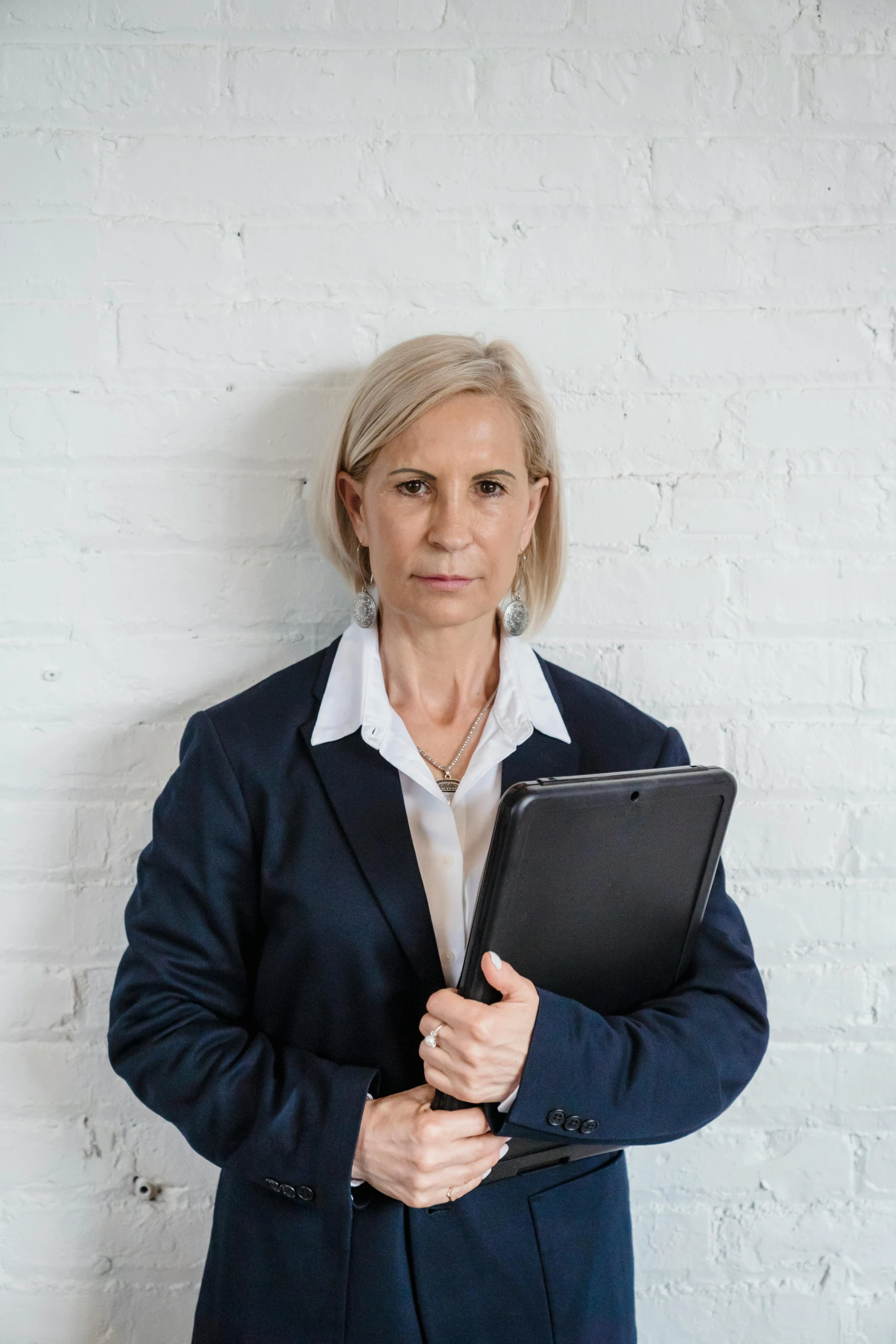 an older woman is holding her laptop