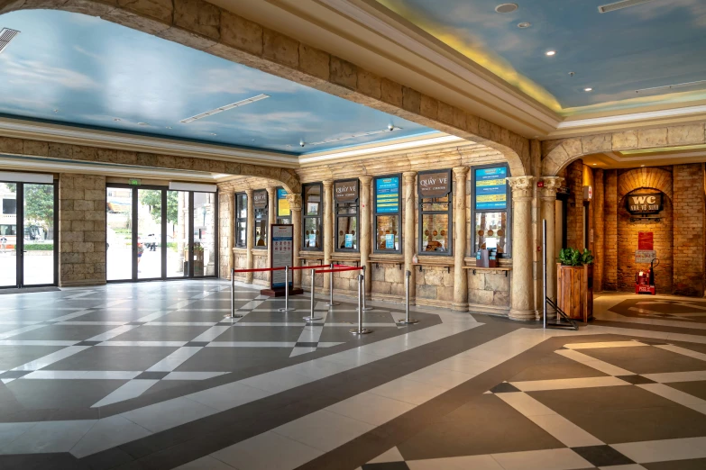 a room with large doors and checkered flooring