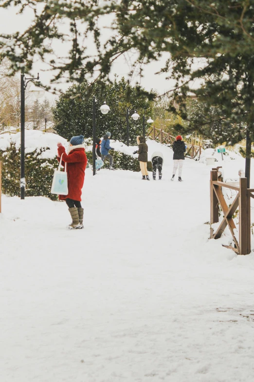 a child walking down a snow covered hill with other people