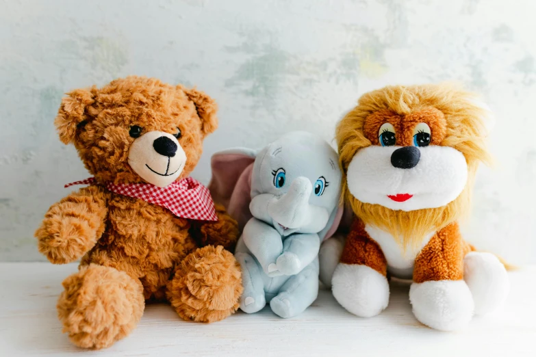 three small stuffed animals sitting in a row