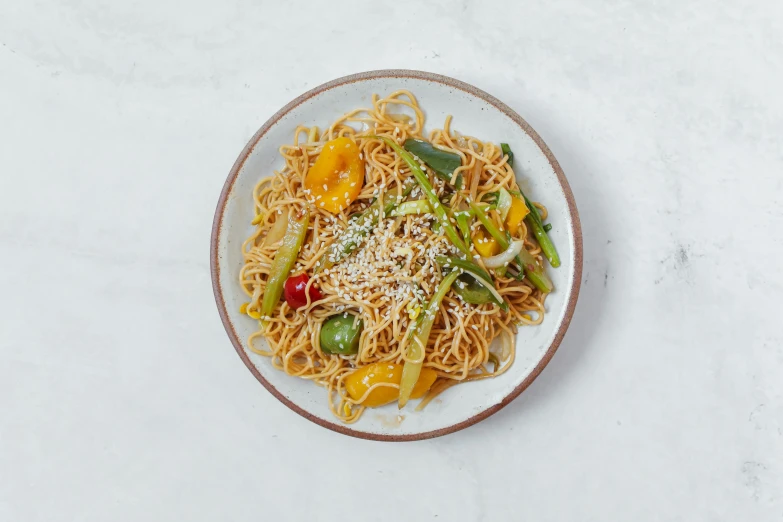 a plate that has noodles on it with vegetables