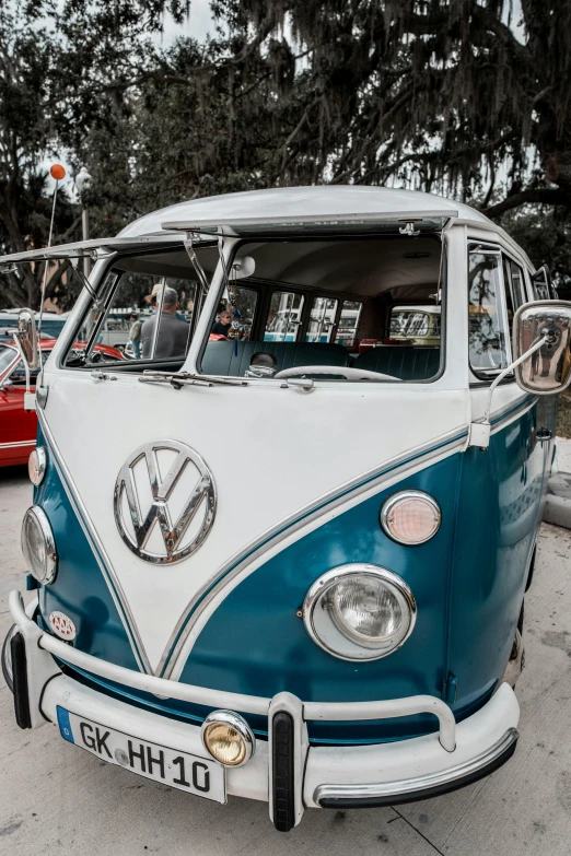 an old blue and white van is parked