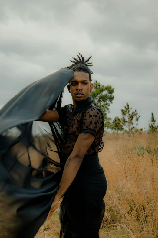 a man with a veil standing in a field