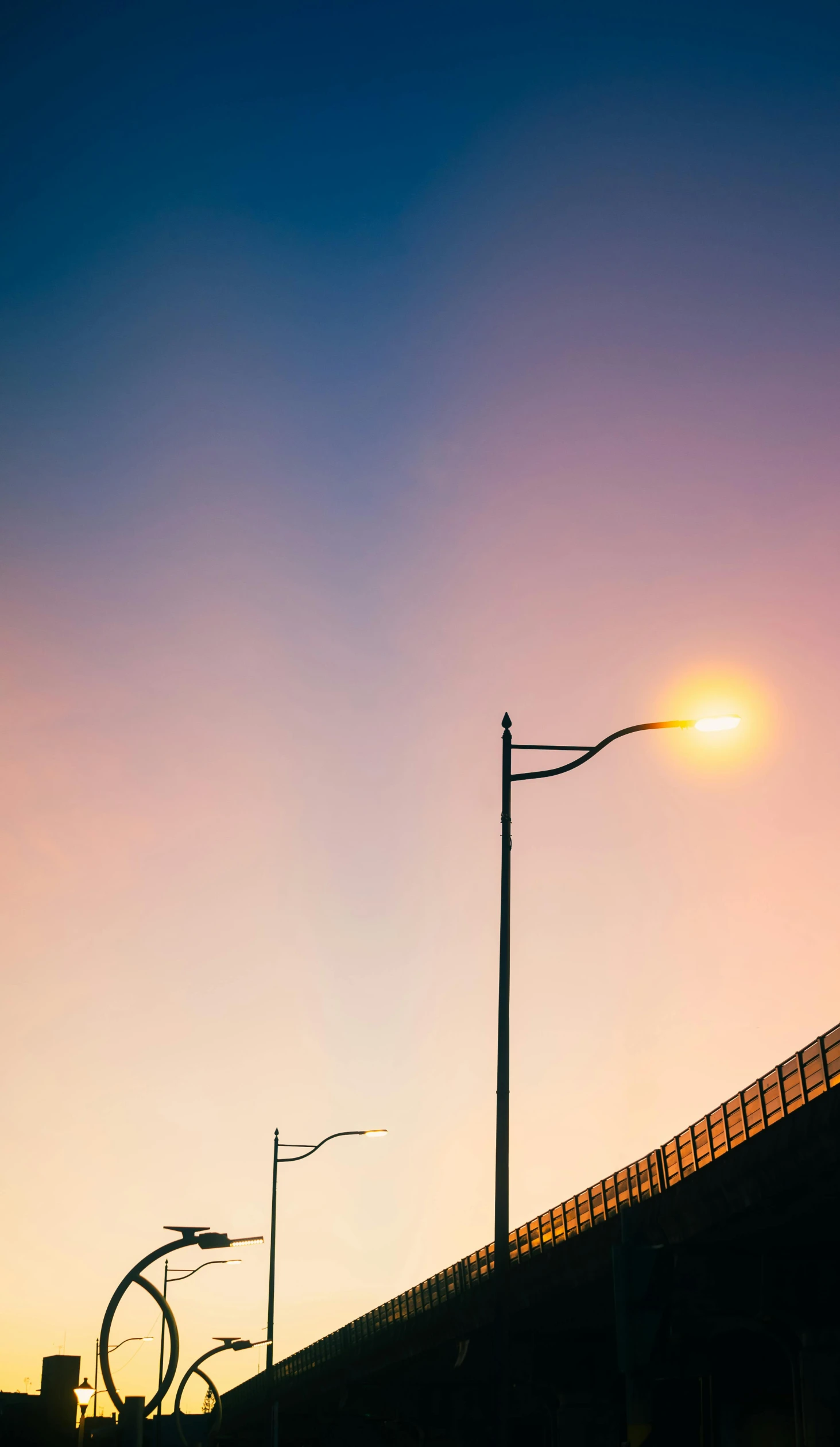 a streetlight sits at the top of a bridge