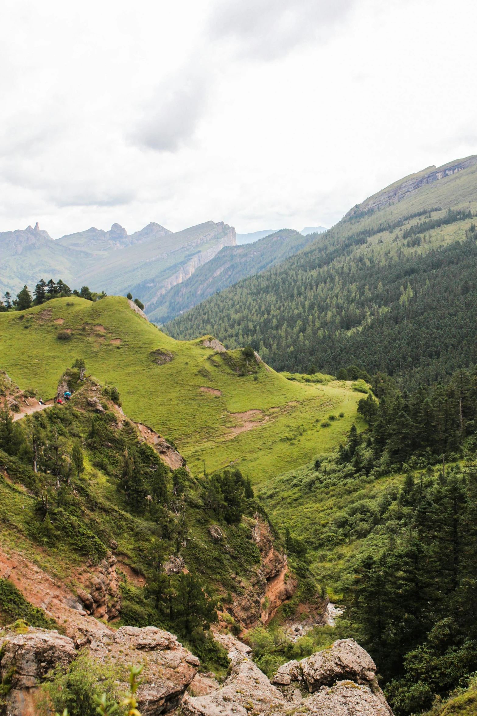 two people on a trail on a hill