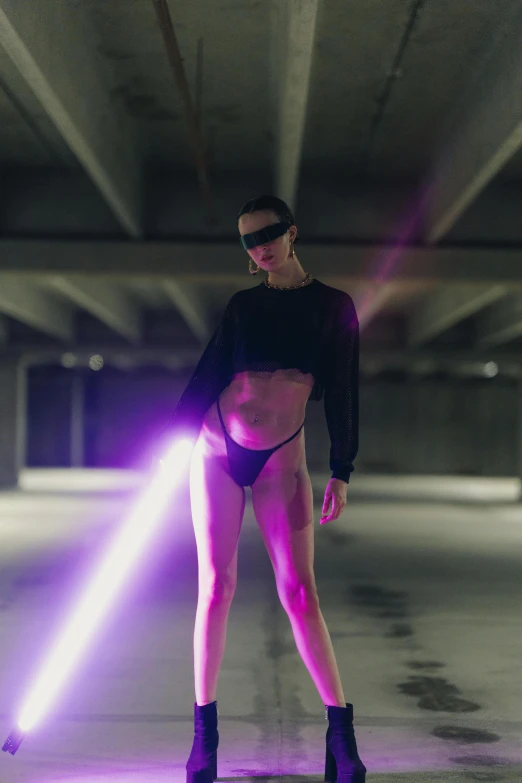 a woman with purple lights holding a laser stick