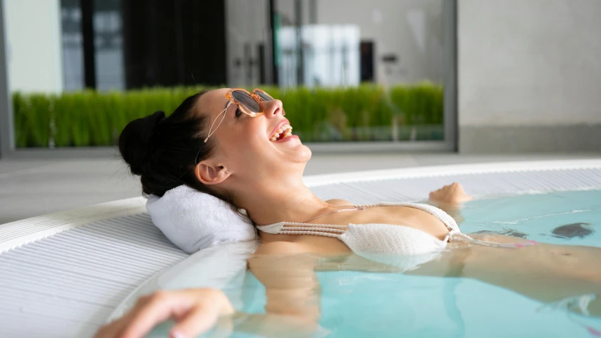 a beautiful woman laying in the water and relaxing